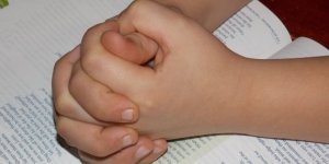 Child praying worship school