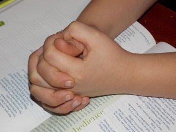 Child praying worship school