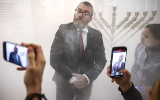 Far-right Polish MP uses fire extinguisher to put out Hanukah candles