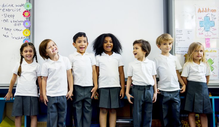 Group of diverse children in non faith specific school uniforms